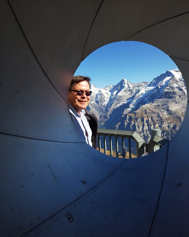 Knut Erik Jahr i Alpene, med snødekte fjelltopper bak seg